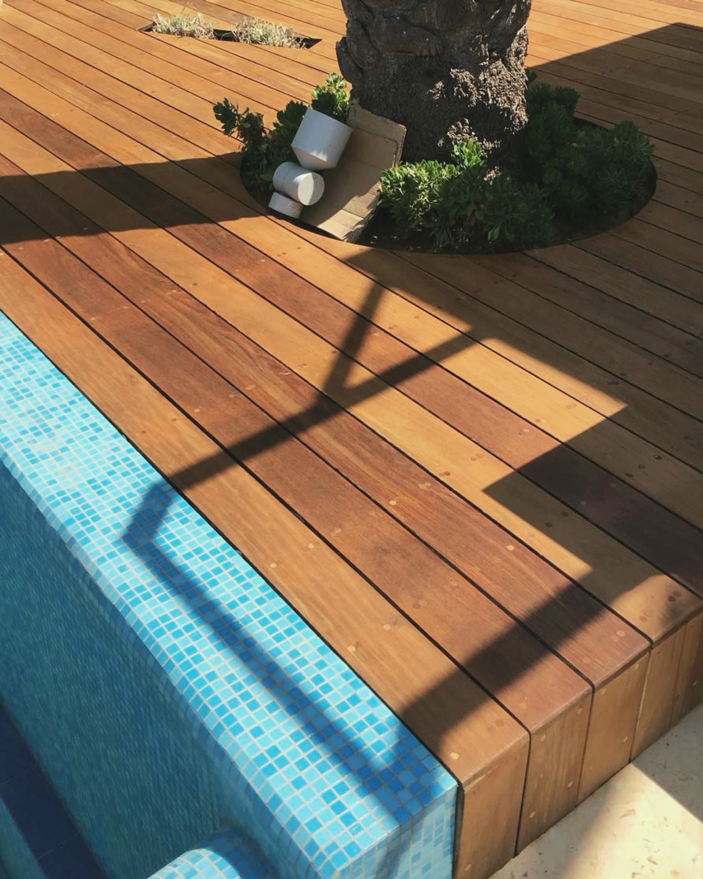 Poolside wood deck in Caesarea after restoration, cleaned and oiled