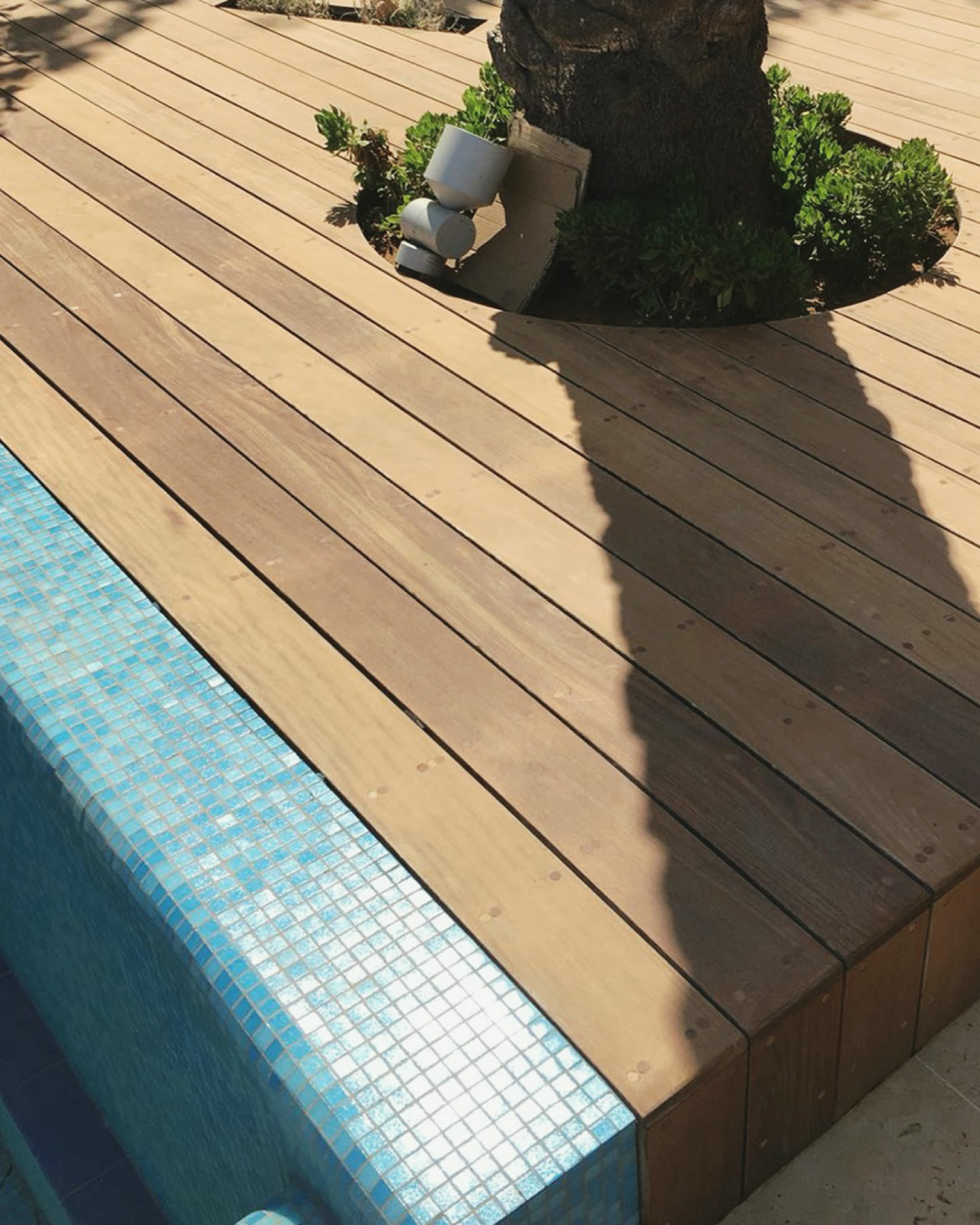 Poolside wood deck in Caesarea after sanding and cleaning, ready for oil